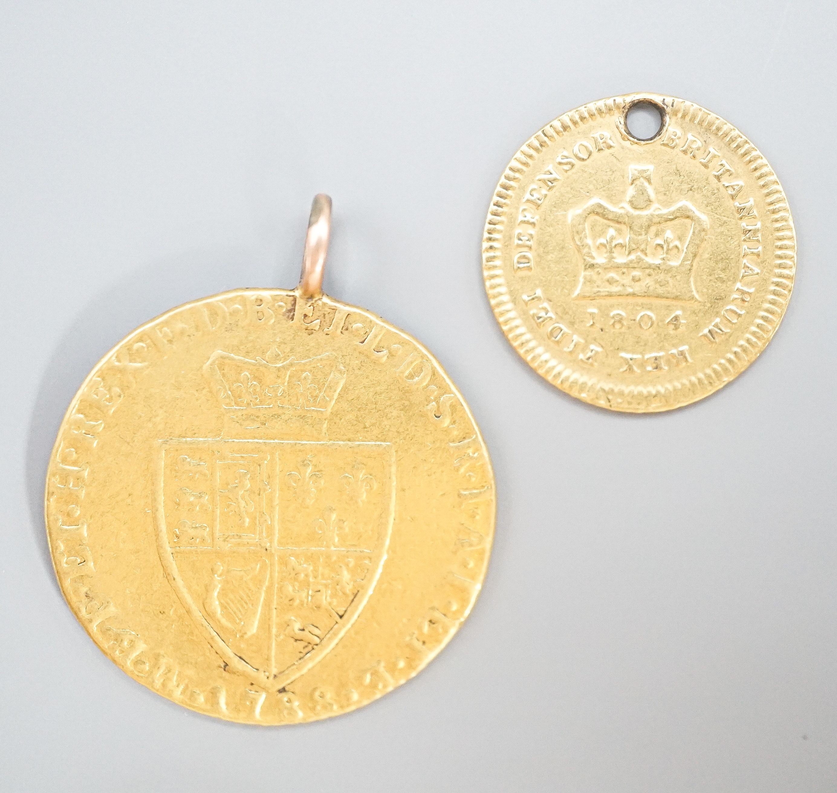 A George III 1788 gold guinea, now with pendant loop and an 1804 gold one third guinea(hole).